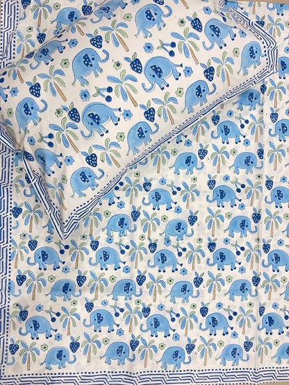 Patterned fabric with blue elephants and green leaves on a white background